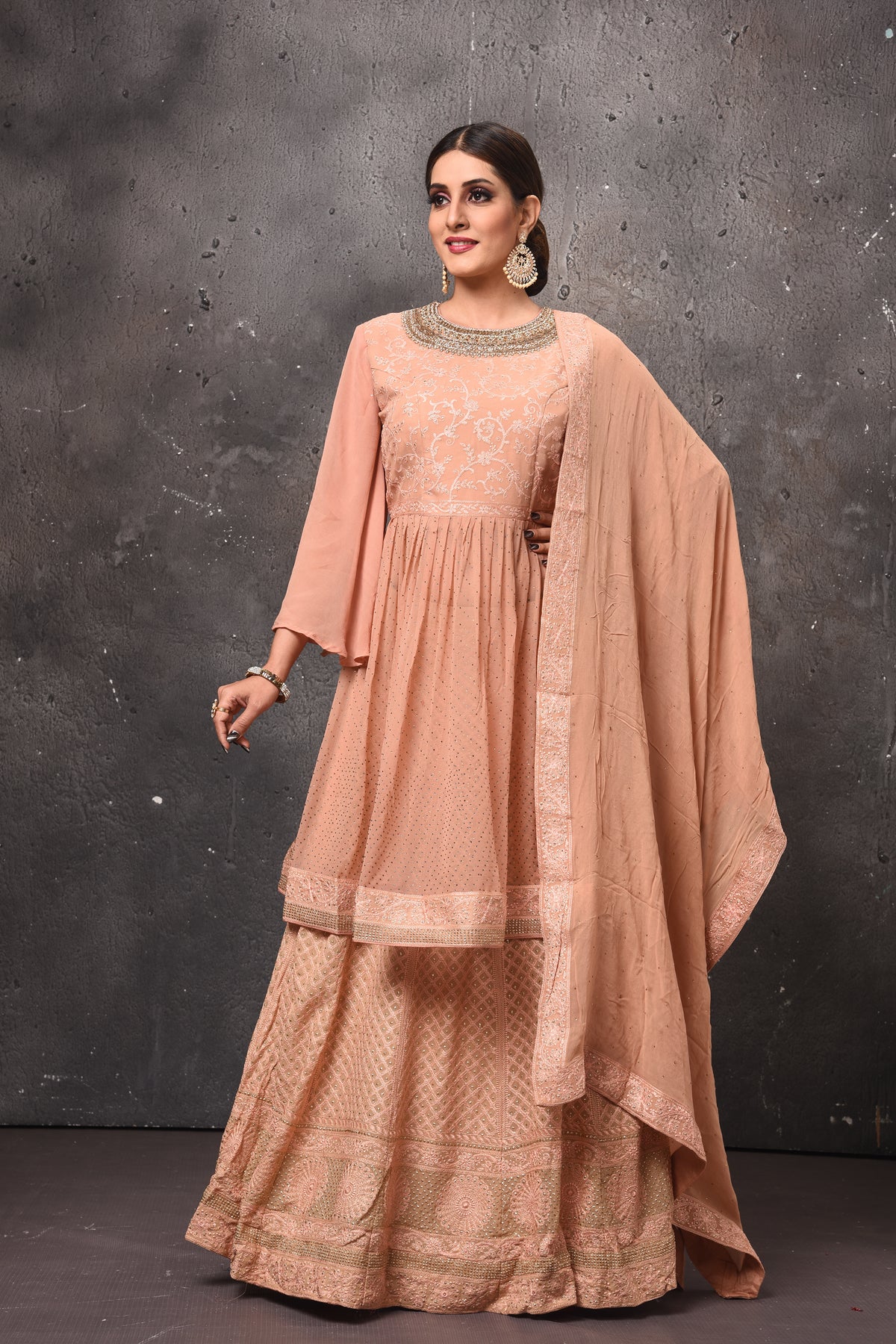 Buy beautiful peach peplum sharara suit online in USA with dupatta. Get set for weddings and festive occasions in exclusive designer Anarkali suits, wedding gown, salwar suits, gharara suits, Indowestern dresses from Pure Elegance Indian fashion store in USA.-full view