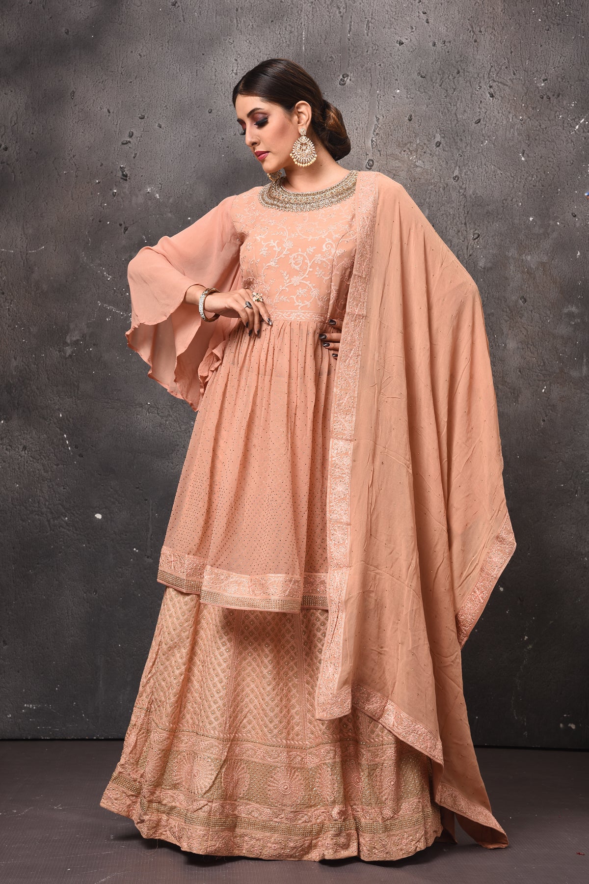 Buy beautiful beige embroidered peplum skirt set online in USA with dupatta. Get set for weddings and festive occasions in exclusive designer Anarkali suits, wedding gown, salwar suits, gharara suits, Indowestern dresses from Pure Elegance Indian fashion store in USA.-front