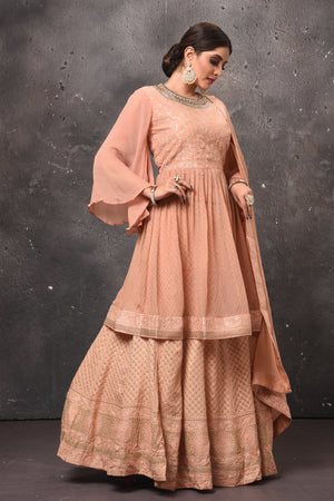 Buy beautiful peach peplum sharara suit online in USA with dupatta. Get set for weddings and festive occasions in exclusive designer Anarkali suits, wedding gown, salwar suits, gharara suits, Indowestern dresses from Pure Elegance Indian fashion store in USA.-right