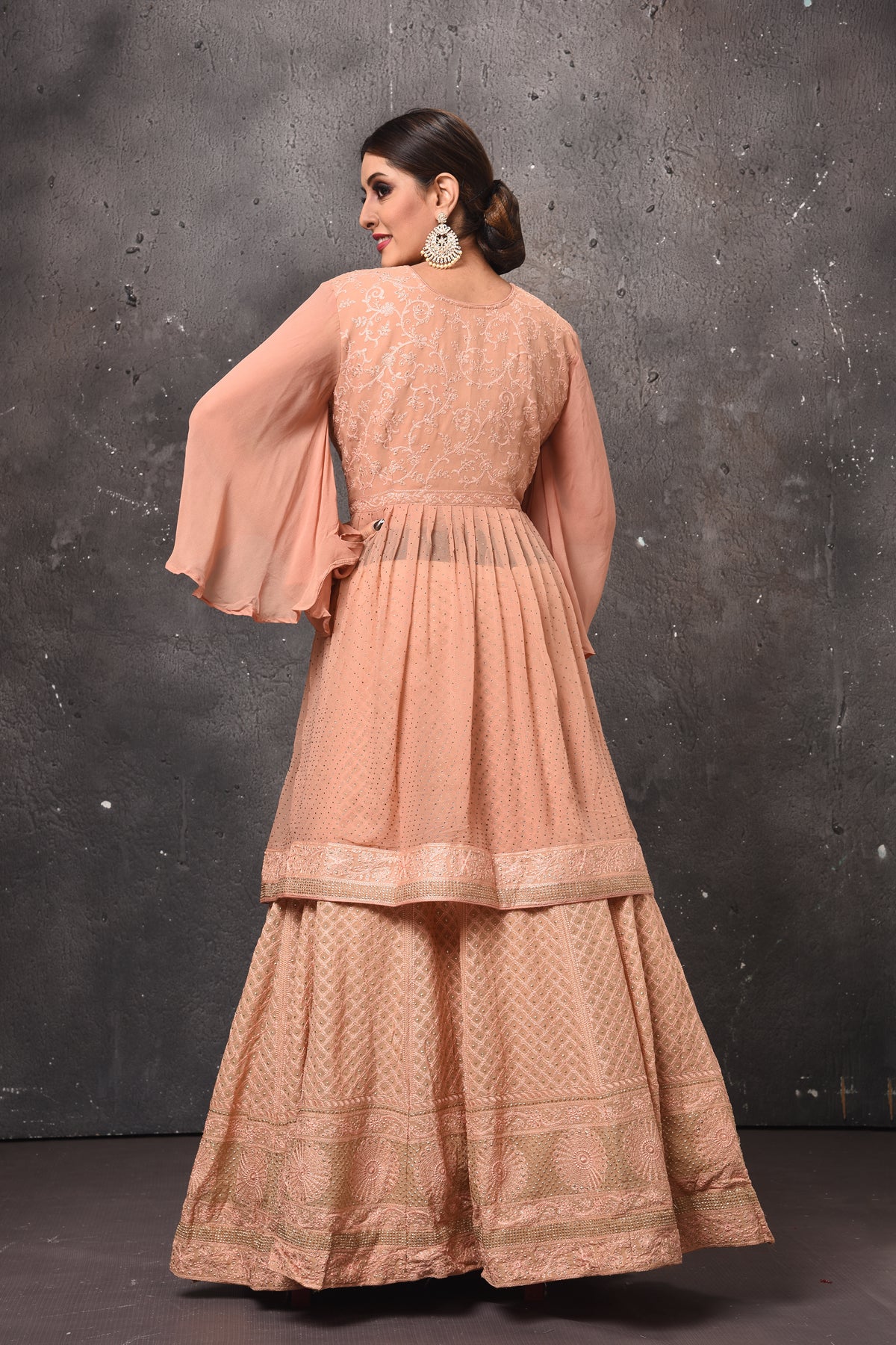 Buy beautiful peach peplum sharara suit online in USA with dupatta. Get set for weddings and festive occasions in exclusive designer Anarkali suits, wedding gown, salwar suits, gharara suits, Indowestern dresses from Pure Elegance Indian fashion store in USA.-back