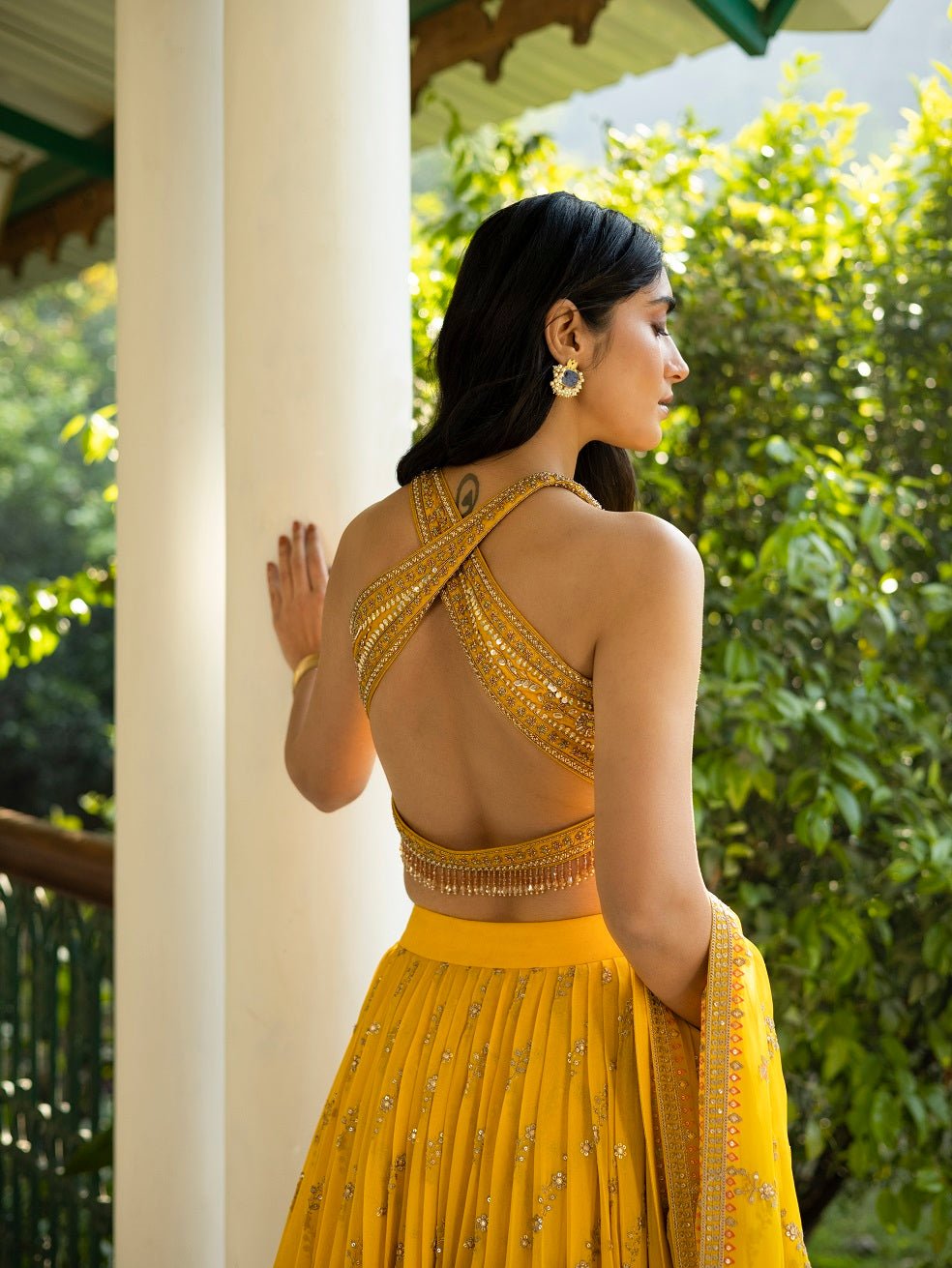 Shop stunning yellow embroidered ethnic lehenga online in USA with dupatta. Get set for weddings and festive occasions in exclusive designer Anarkali suits, wedding gown, salwar suits, gharara suits, Indowestern dresses from Pure Elegance Indian fashion store in USA.-back
