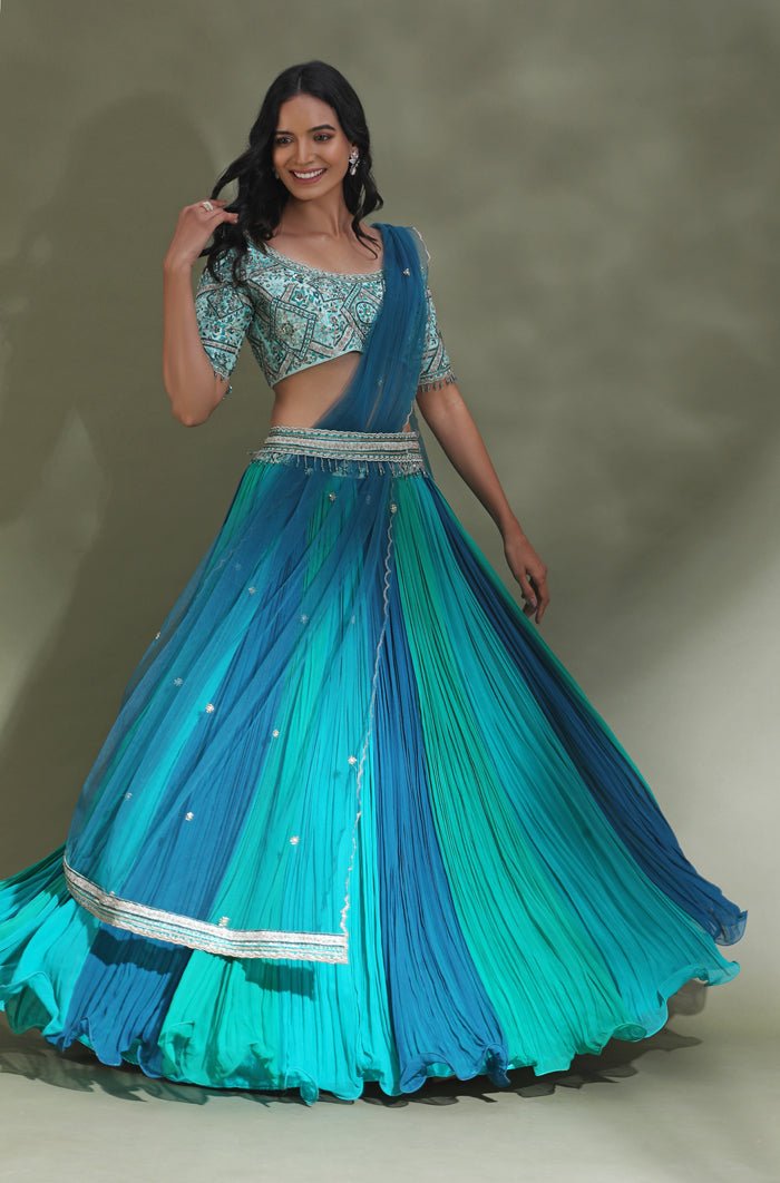 Shop stunning sea green and blue belted designer lehenga online in USA. Look your best at weddings and parties in Indian dresses, designer lehengas, Anarkali suits, designer gowns, salwar suits, sharara suits from Pure Elegance Indian fashion store in USA.-flare