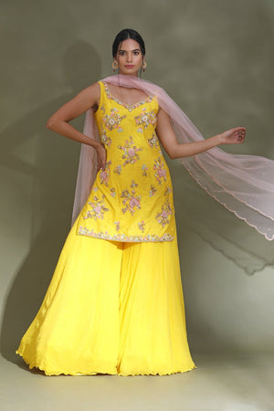 Shop stunning bright yellow embroidered sharara suit online in USA with powder pink dupatta. Look your best at weddings and parties in Indian dresses, designer lehengas, Anarkali suits, designer gowns, salwar suits, sharara suits from Pure Elegance Indian fashion store in USA.-front