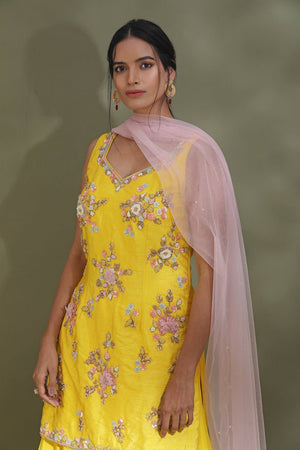 Shop stunning bright yellow embroidered sharara suit online in USA with powder pink dupatta. Look your best at weddings and parties in Indian dresses, designer lehengas, Anarkali suits, designer gowns, salwar suits, sharara suits from Pure Elegance Indian fashion store in USA.-closeup