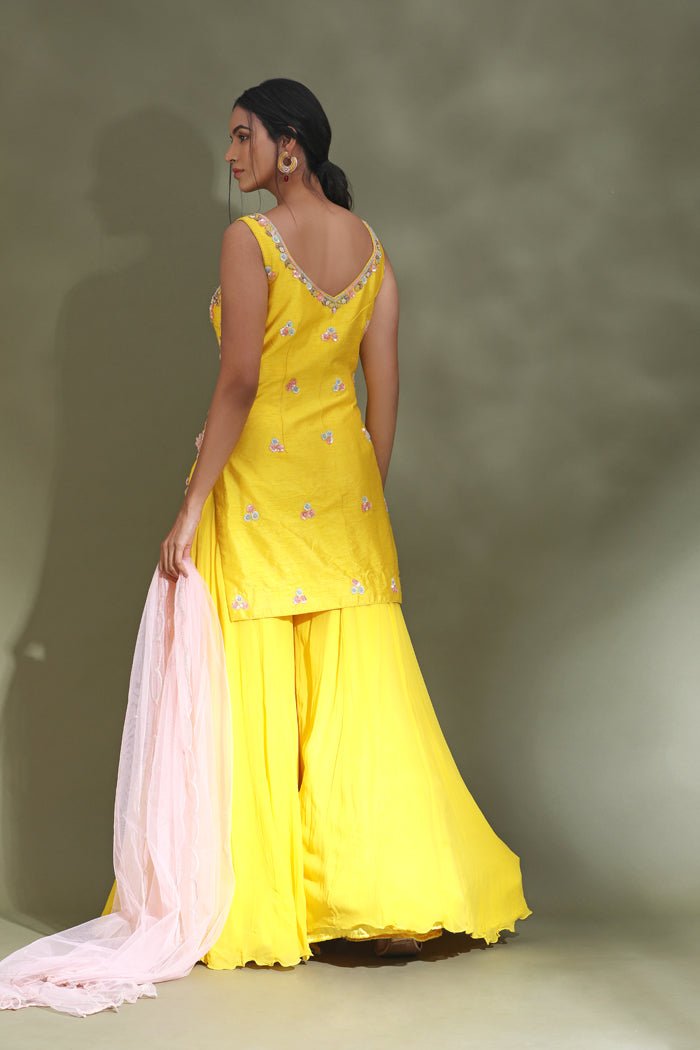 Shop stunning bright yellow embroidered sharara suit online in USA with powder pink dupatta. Look your best at weddings and parties in Indian dresses, designer lehengas, Anarkali suits, designer gowns, salwar suits, sharara suits from Pure Elegance Indian fashion store in USA.-back