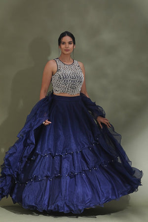 Buy beautiful dark blue ruffle lehenga online in USA with embellished blouse with dupatta. Look your best at weddings and parties in Indian dresses, designer lehengas, Anarkali suits, designer gowns, salwar suits, sharara suits from Pure Elegance Indian fashion store in USA.-front