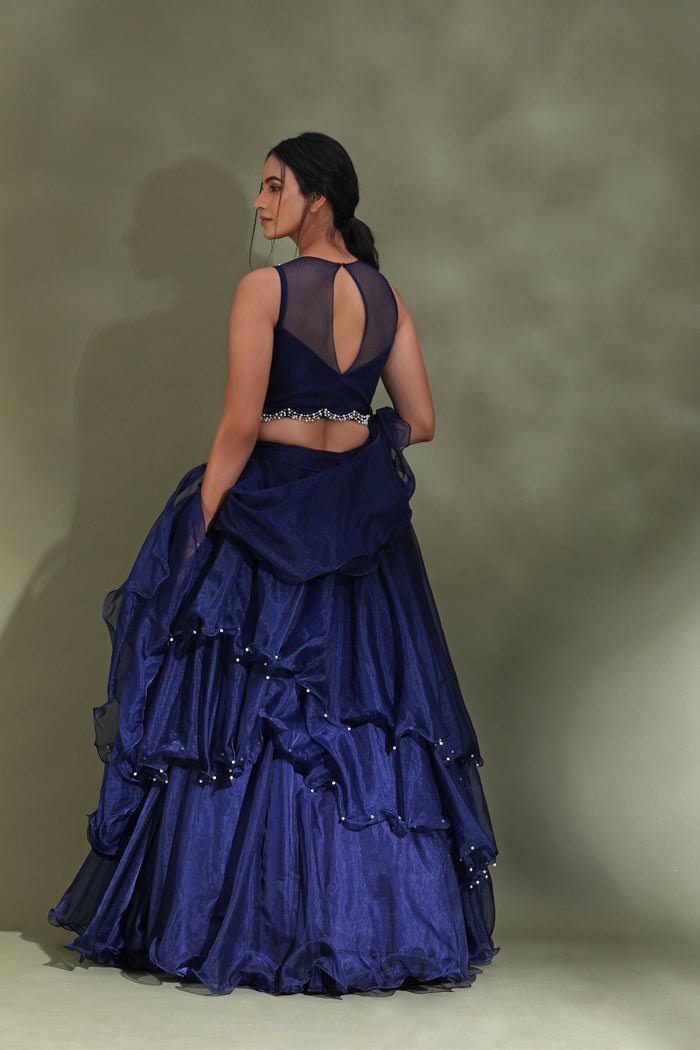 Buy beautiful dark blue ruffle lehenga online in USA with embellished blouse with dupatta. Look your best at weddings and parties in Indian dresses, designer lehengas, Anarkali suits, designer gowns, salwar suits, sharara suits from Pure Elegance Indian fashion store in USA.-back