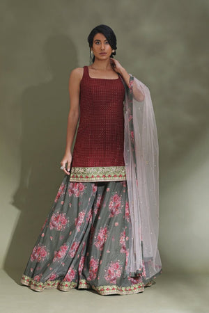 Buy beautiful maroon and grey floral embroidered sharara suit online in USA with dupatta. Look your best at weddings and parties in Indian dresses, designer lehengas, Anarkali suits, designer gowns, salwar suits, sharara suits from Pure Elegance Indian fashion store in USA.-front