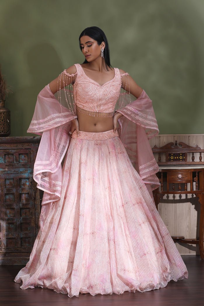 Shop powder pink designer lehenga online in USA with ruffle dupatta. Look your best at weddings and parties in Indian dresses, designer lehengas, Anarkali suits, designer gowns, salwar suits, sharara suits from Pure Elegance Indian fashion store in USA.-full view