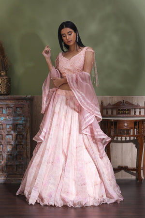 Shop powder pink contemporary lehenga online in USA with dupatta. Look your best at weddings and parties in Indian dresses, designer lehengas, Anarkali suits, designer gowns, salwar suits, sharara suits from Pure Elegance Indian fashion store in USA.-side