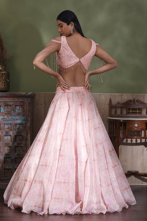 Shop powder pink contemporary lehenga online in USA with dupatta. Look your best at weddings and parties in Indian dresses, designer lehengas, Anarkali suits, designer gowns, salwar suits, sharara suits from Pure Elegance Indian fashion store in USA.-back