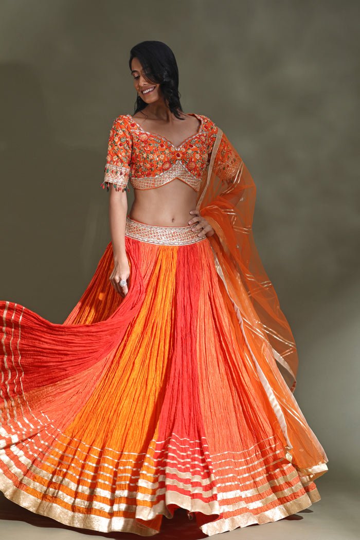 Shop beautiful orange and red lehenga online in USA with gota border and dupatta. Look your best at weddings and parties in Indian dresses, designer lehengas, Anarkali suits, designer gowns, salwar suits, sharara suits from Pure Elegance Indian fashion store in USA.-skirt