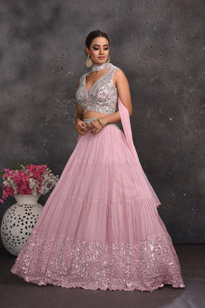 Buy stunning powder pink mirror work lehenga online in USA with dupatta. Look your best at weddings and special occasions in exclusive designer lehengas, Anarkali suits, sharara suits. designer gowns and Indian dresses from Pure Elegance Indian fashion store in USA.-side