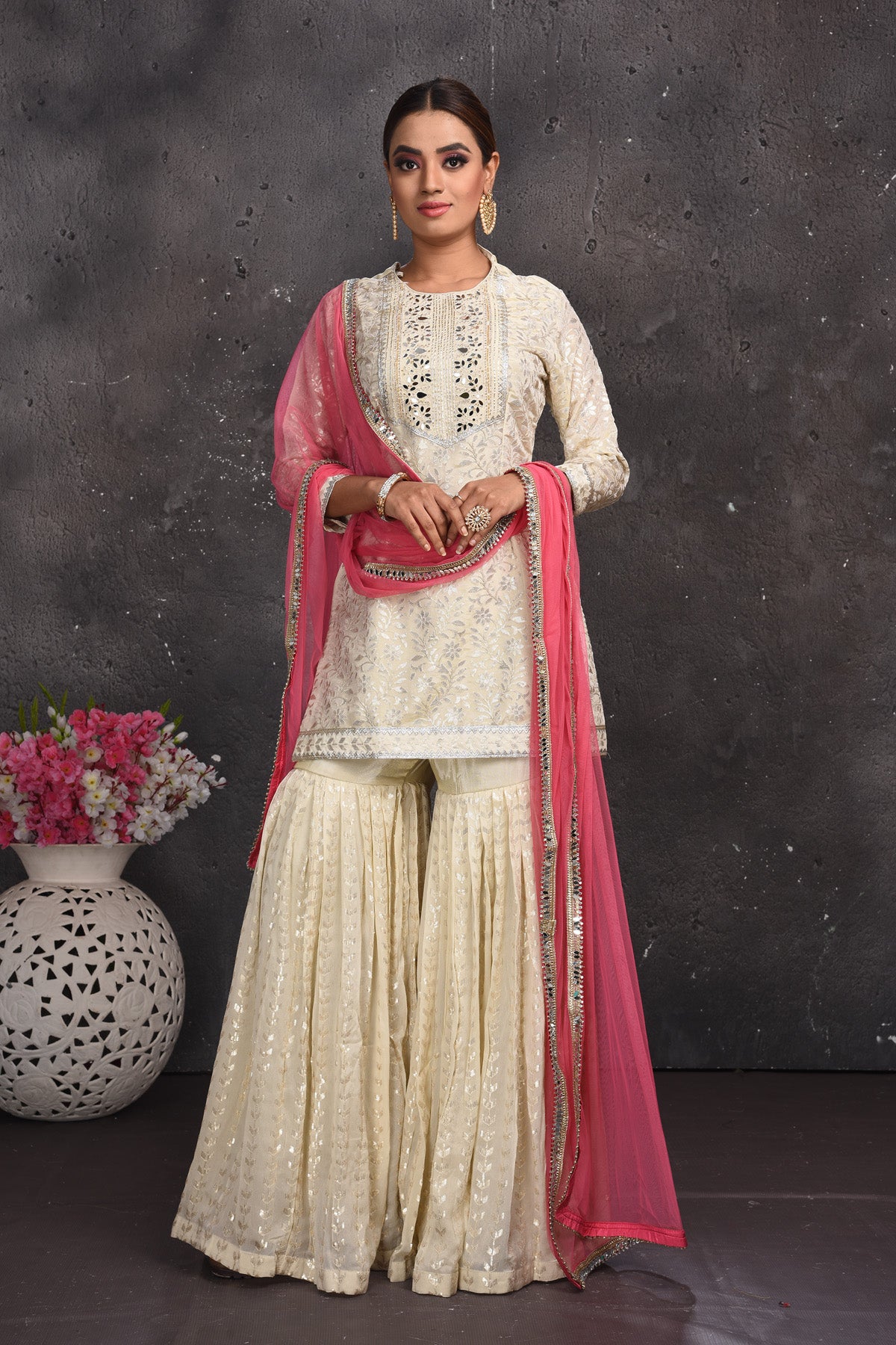Shop beautiful off-white embroidered gharara suit online in USA with pink dupatta. Look your best at weddings and special occasions in exclusive designer lehengas, Anarkali suits, sharara suits. designer gowns and Indian dresses from Pure Elegance Indian fashion store in USA.-full view