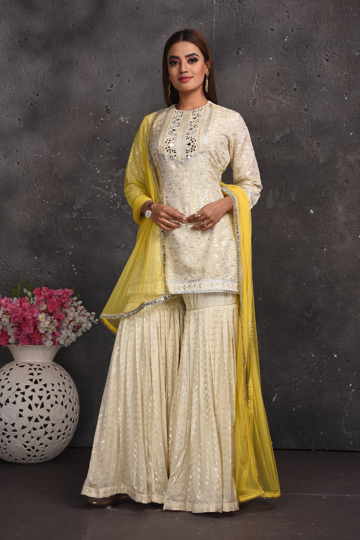 Shop gorgeous off-white embroidered gharara suit online in USA with yellow dupatta. Look your best at weddings and special occasions in exclusive designer lehengas, Anarkali suits, sharara suits. designer gowns and Indian dresses from Pure Elegance Indian fashion store in USA.-full view