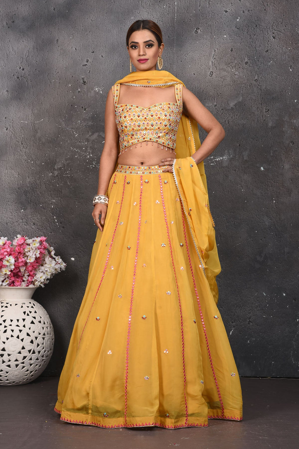 Buy beautiful mustard mirror work designer lehenga online in USA with dupatta. Look your best at weddings and special occasions in exclusive designer lehengas, Anarkali suits, sharara suits. designer gowns and Indian dresses from Pure Elegance Indian fashion store in USA.-full view