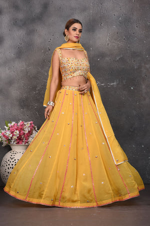 Buy beautiful mustard mirror work designer lehenga online in USA with dupatta. Look your best at weddings and special occasions in exclusive designer lehengas, Anarkali suits, sharara suits. designer gowns and Indian dresses from Pure Elegance Indian fashion store in USA.-skirt