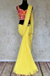 Buy beautiful lemon yellow embroidered georgette saree online in USA with pink embroidered blouse. Look your best at weddings and parties in Indian sarees, designer saris, printed sarees, embroidered sarees from Pure Elegance Indian fashion store in USA.-full view