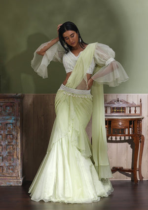 Buy beautiful mint green contemporary lehenga online in USA with draped dupatta. Look your best at weddings and parties in Indian dresses, designer lehengas, Anarkali suits, designer gowns, salwar suits, sharara suits from Pure Elegance Indian fashion store in USA.-front