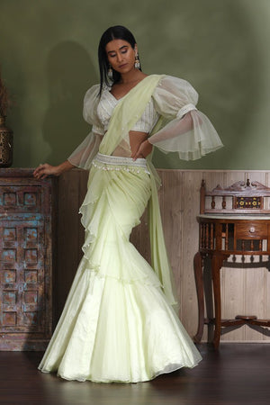 Buy beautiful mint green contemporary lehenga online in USA with draped dupatta. Look your best at weddings and parties in Indian dresses, designer lehengas, Anarkali suits, designer gowns, salwar suits, sharara suits from Pure Elegance Indian fashion store in USA.-left