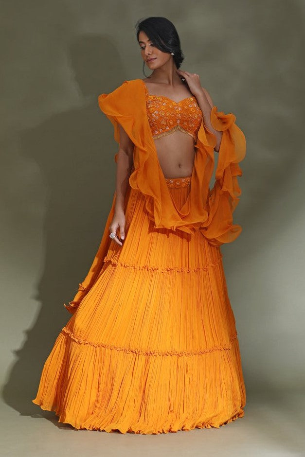 Buy stunning orange tiered lehenga online in USA with ruffle dupatta. Look your best at weddings and parties in Indian dresses, designer lehengas, Anarkali suits, designer gowns, salwar suits, sharara suits from Pure Elegance Indian fashion store in USA.-full view