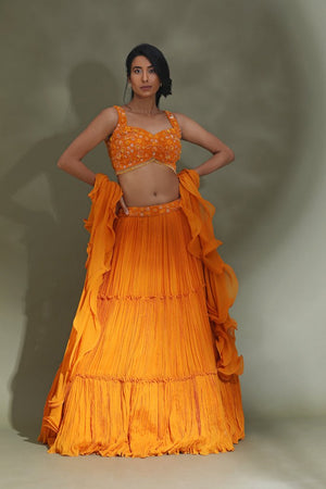 Buy stunning orange tiered lehenga online in USA with ruffle dupatta. Look your best at weddings and parties in Indian dresses, designer lehengas, Anarkali suits, designer gowns, salwar suits, sharara suits from Pure Elegance Indian fashion store in USA.-front