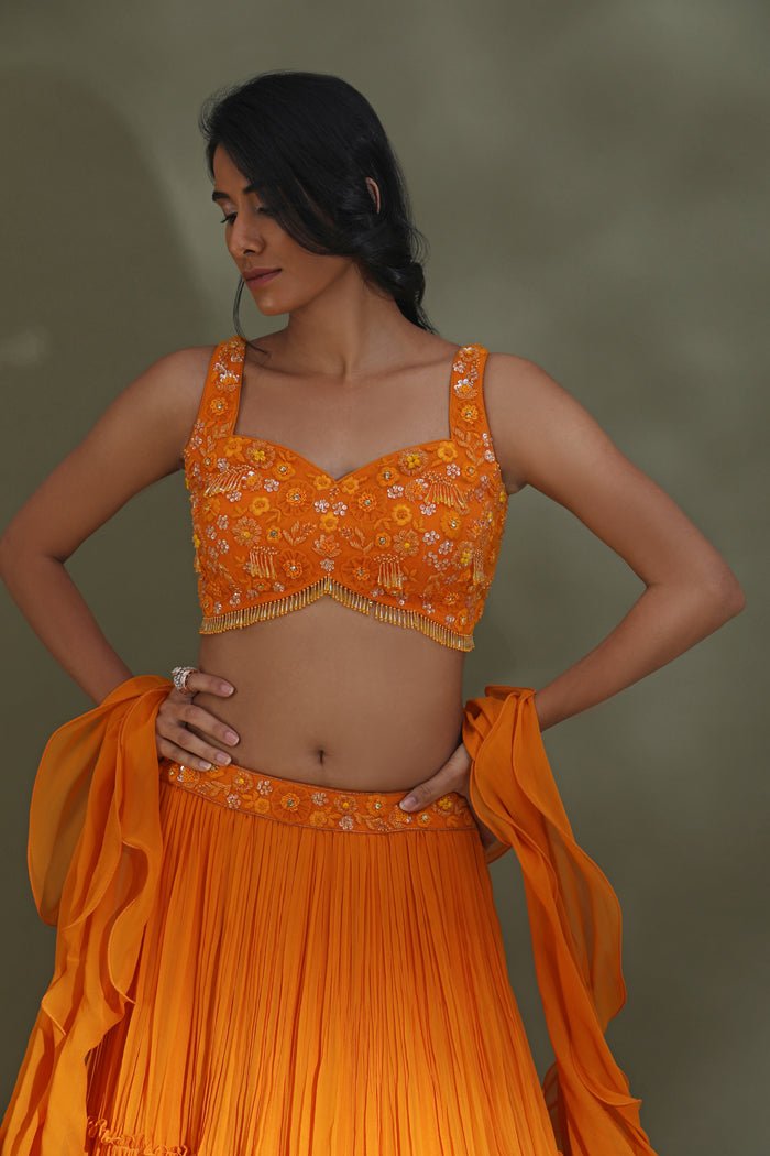 Buy stunning orange tiered lehenga online in USA with ruffle dupatta. Look your best at weddings and parties in Indian dresses, designer lehengas, Anarkali suits, designer gowns, salwar suits, sharara suits from Pure Elegance Indian fashion store in USA.-closeup