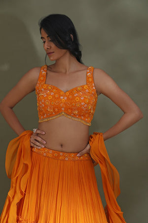 Buy stunning orange tiered lehenga online in USA with ruffle dupatta. Look your best at weddings and parties in Indian dresses, designer lehengas, Anarkali suits, designer gowns, salwar suits, sharara suits from Pure Elegance Indian fashion store in USA.-closeup