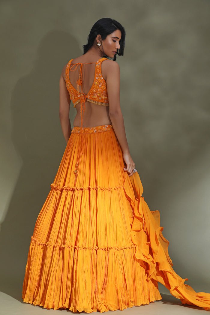 Buy stunning orange tiered lehenga online in USA with ruffle dupatta. Look your best at weddings and parties in Indian dresses, designer lehengas, Anarkali suits, designer gowns, salwar suits, sharara suits from Pure Elegance Indian fashion store in USA.-back
