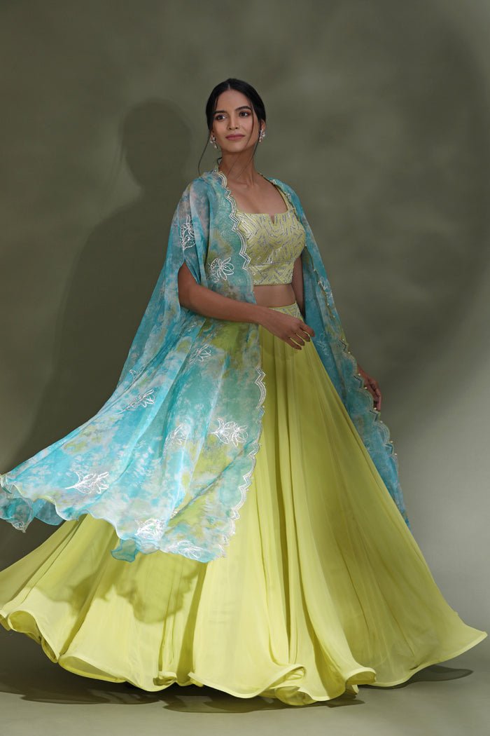 Shop beautiful bright yellow designer lehenga online in USA with blue dupatta. Look your best at weddings and parties in Indian dresses, designer lehengas, Anarkali suits, designer gowns, salwar suits, sharara suits from Pure Elegance Indian fashion store in USA.-lehenga