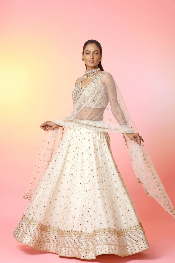 Buy beautiful cream mirror work lehenga online in USA with dupatta. Look your best at weddings and parties in Indian dresses, designer lehengas, Anarkali suits, designer gowns, salwar suits, sharara suits, embroidered sarees, designer sarees from Pure Elegance Indian fashion store in USA.-full view
