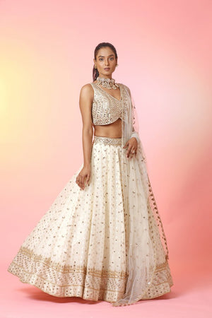 Buy beautiful cream mirror work lehenga online in USA with dupatta. Look your best at weddings and parties in Indian dresses, designer lehengas, Anarkali suits, designer gowns, salwar suits, sharara suits, embroidered sarees, designer sarees from Pure Elegance Indian fashion store in USA.-side