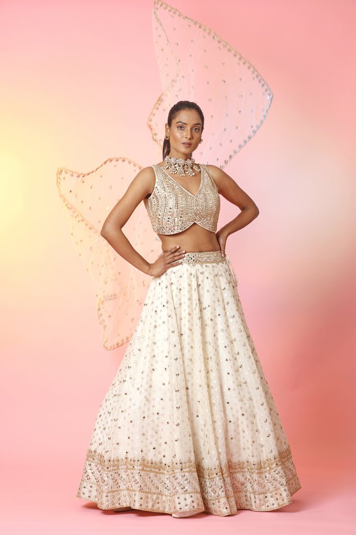 Buy beautiful cream mirror work lehenga online in USA with dupatta. Look your best at weddings and parties in Indian dresses, designer lehengas, Anarkali suits, designer gowns, salwar suits, sharara suits, embroidered sarees, designer sarees from Pure Elegance Indian fashion store in USA.-front