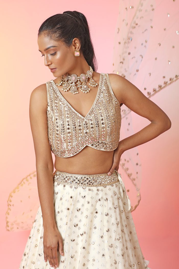 Buy beautiful cream mirror work lehenga online in USA with dupatta. Look your best at weddings and parties in Indian dresses, designer lehengas, Anarkali suits, designer gowns, salwar suits, sharara suits, embroidered sarees, designer sarees from Pure Elegance Indian fashion store in USA.-closeup