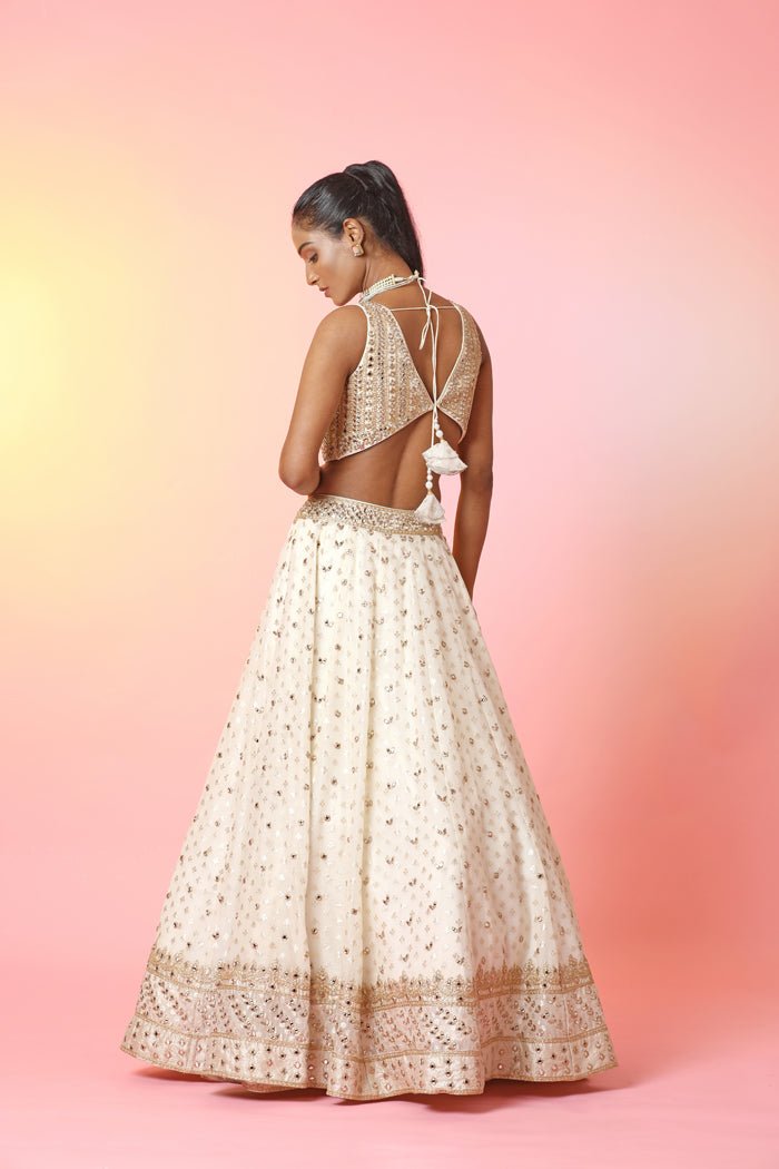 Buy beautiful cream mirror work lehenga online in USA with dupatta. Look your best at weddings and parties in Indian dresses, designer lehengas, Anarkali suits, designer gowns, salwar suits, sharara suits, embroidered sarees, designer sarees from Pure Elegance Indian fashion store in USA.-back