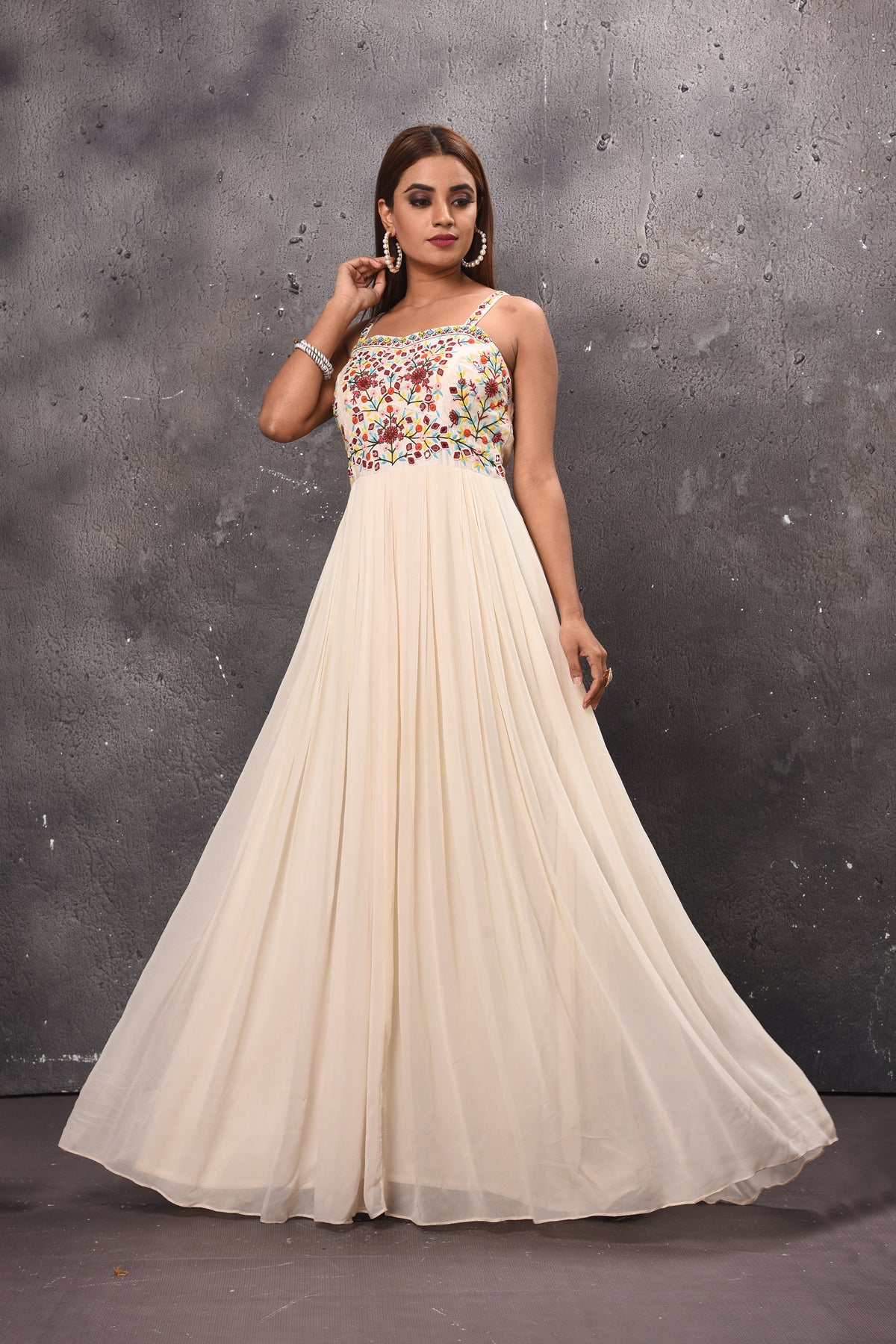 Shop stunning cream maxi dress online in USA with embroidered bodice. Get set for weddings and festive occasions in exclusive designer Anarkali suits, wedding gown, salwar suits, gharara suits, Indowestern dresses from Pure Elegance Indian fashion store in USA.-front