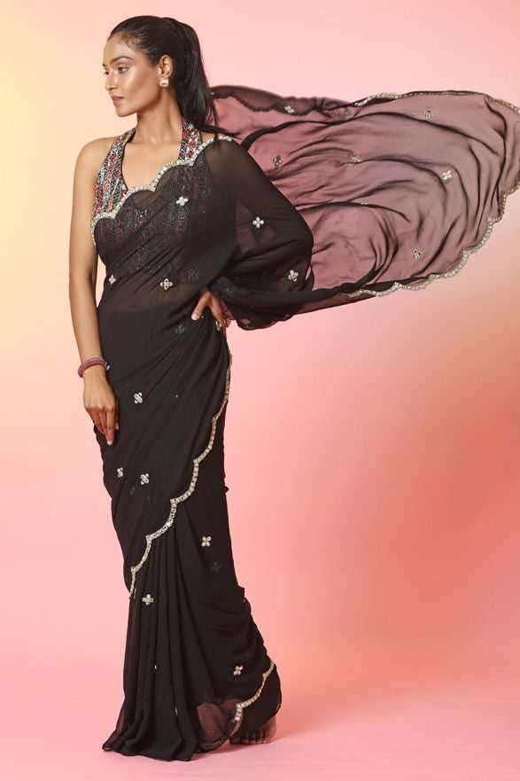 Buy beautiful black mirror work saree online in USA with halter neck blouse. Look your best at weddings and parties in Indian dresses, designer lehengas, Anarkali suits, designer gowns, salwar suits, sharara suits, embroidered sarees, designer sarees from Pure Elegance Indian fashion store in USA.-front