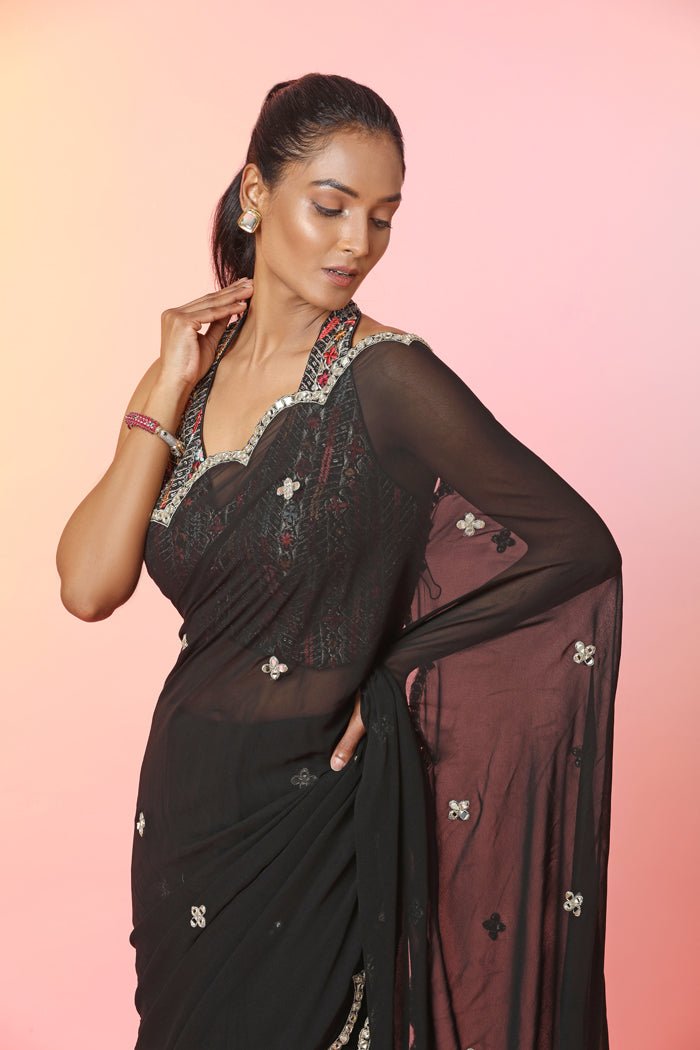 Buy beautiful black mirror work saree online in USA with halter neck blouse. Look your best at weddings and parties in Indian dresses, designer lehengas, Anarkali suits, designer gowns, salwar suits, sharara suits, embroidered sarees, designer sarees from Pure Elegance Indian fashion store in USA.-closeup