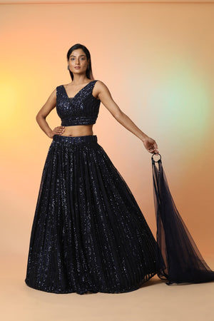 Buy midnight blue embellished designer lehenga online in USA with dupatta. Radiate glamor on special occasions in exquisite designer lehengas, Anarkali suits, wedding gowns, partywear saris, Bollywood sarees, fancy sarees from from Pure Elegance Indian saree store in USA.-side
