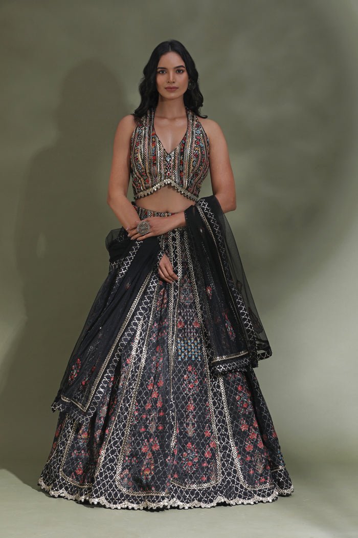 Shop black halter neck designer lehenga online in USA with dupatta. Look your best at weddings and parties in Indian dresses, designer lehengas, Anarkali suits, designer gowns, salwar suits, sharara suits from Pure Elegance Indian fashion store in USA.-full view