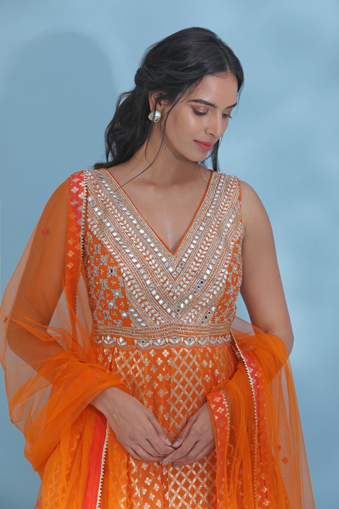 Shop stunning orange mirror work Anarkali online in USA with dupatta. Look your best at weddings and parties in Indian dresses, designer lehengas, Anarkali suits, designer gowns, salwar suits, sharara suits from Pure Elegance Indian fashion store in USA.-closeup