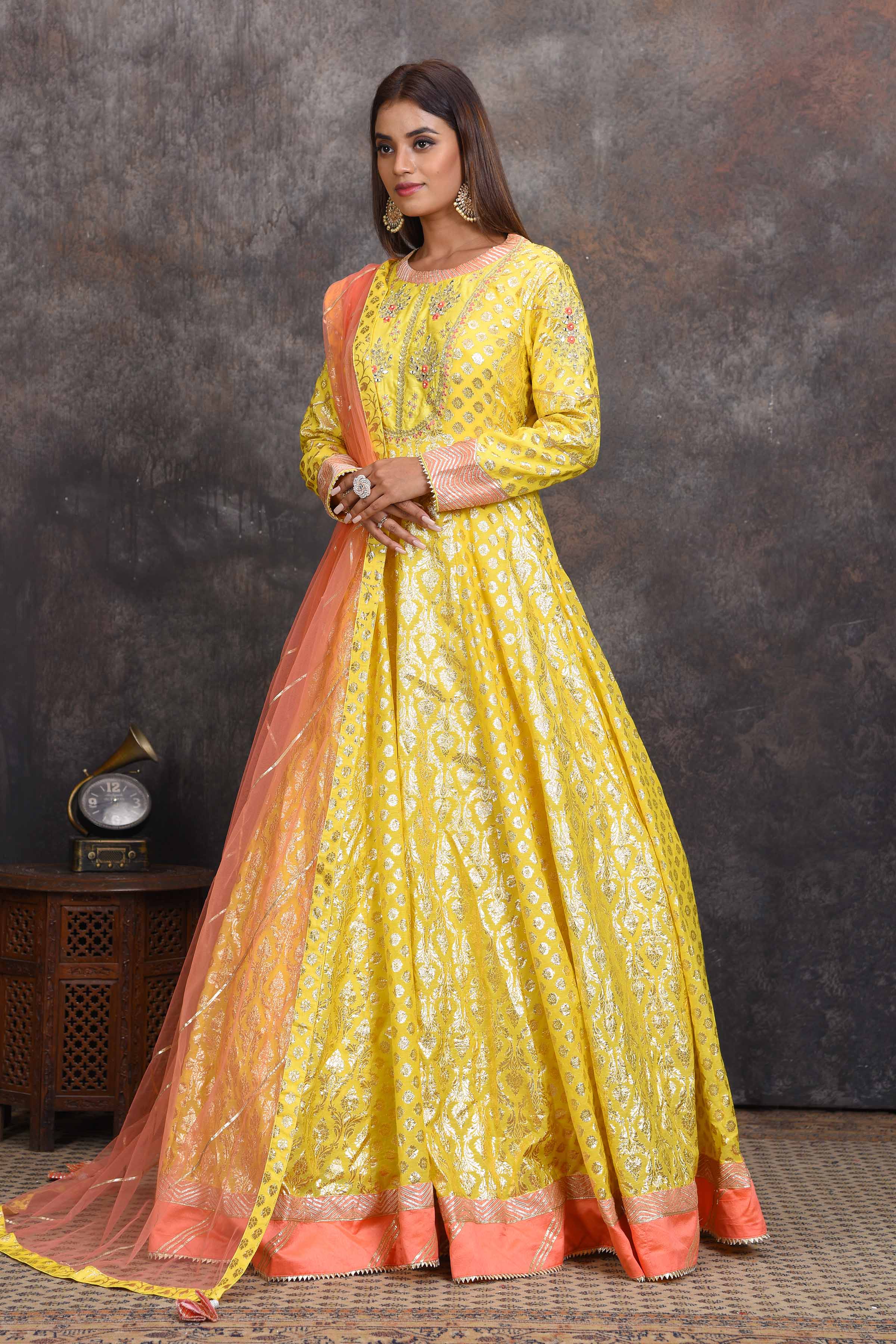 Buy bright yellow chanderi Banarasi Anarkali online in USA with peach dupatta. Set a style statement on special occasions in exquisite designer lehengas, Anarkali suits, sharara suits, salwar suits, Indowestern outfits from Pure Elegance Indian fashion store in USA.-side
