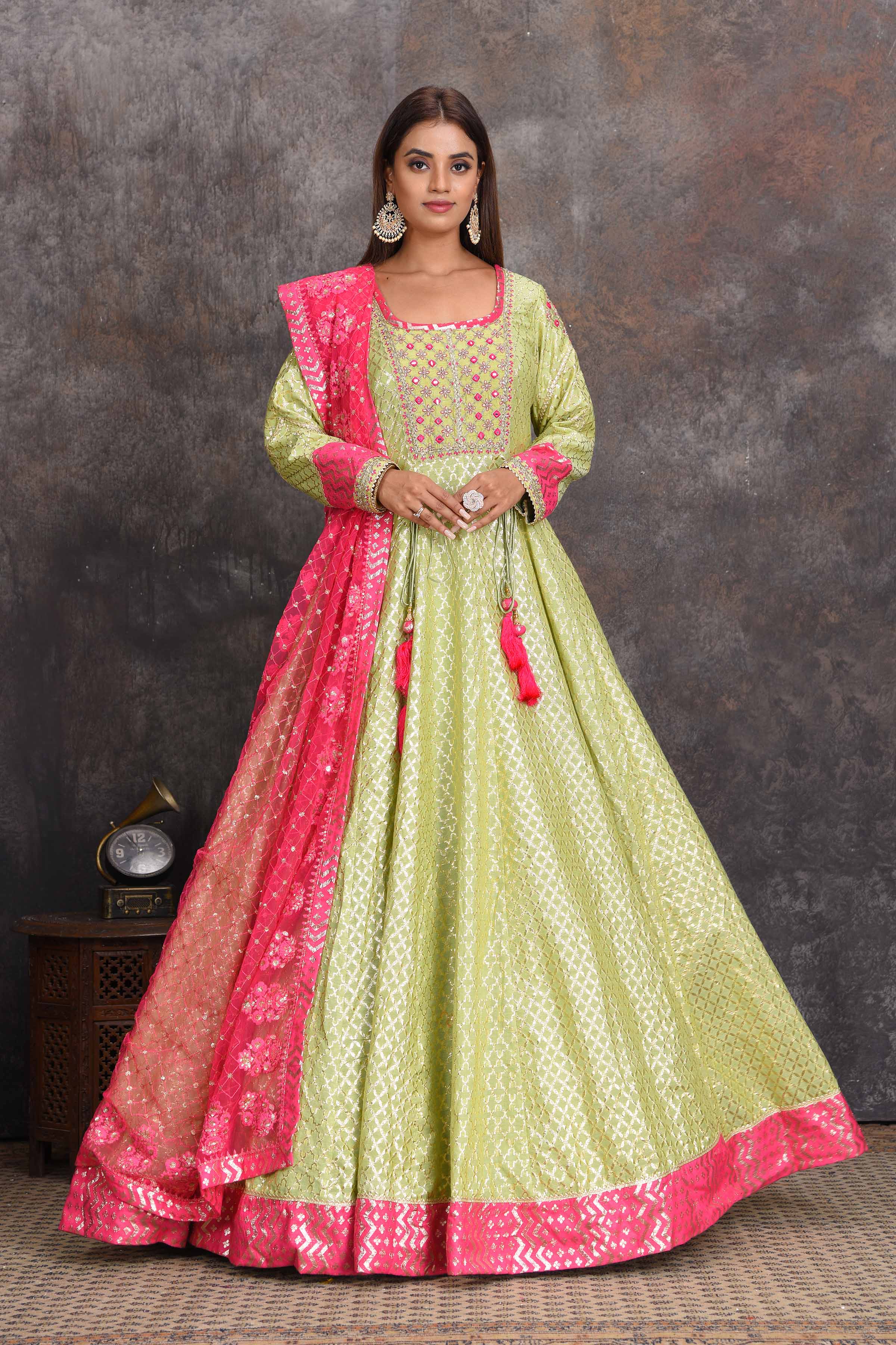 Shop pista green chanderi Banarasi Anarkali online in USA with pink dupatta. Set a style statement on special occasions in exquisite designer lehengas, Anarkali suits, sharara suits, salwar suits, Indowestern outfits from Pure Elegance Indian fashion store in USA.-full view