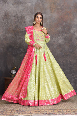 Shop pista green chanderi Banarasi Anarkali online in USA with pink dupatta. Set a style statement on special occasions in exquisite designer lehengas, Anarkali suits, sharara suits, salwar suits, Indowestern outfits from Pure Elegance Indian fashion store in USA.-front