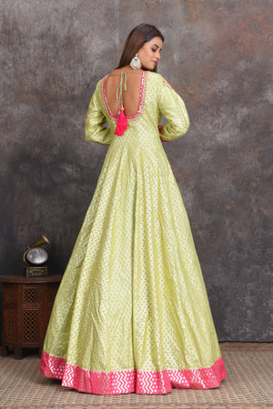 Shop pista green chanderi Banarasi Anarkali online in USA with pink dupatta. Set a style statement on special occasions in exquisite designer lehengas, Anarkali suits, sharara suits, salwar suits, Indowestern outfits from Pure Elegance Indian fashion store in USA.-back