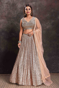 Shop beautiful beige sequin work cocktail lehenga online in USA with dupatta. Look your ethnic best on festive occasions with latest designer sarees, pure silk sarees, Kanchipuram silk sarees, designer dresses, Anarkali suits, gown, embroidered sarees from Pure Elegance Indian fashion store in USA.-full view