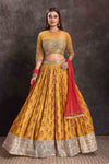 Buy beautiful yellow floral lehenga online in USA with embroidered border and red dupatta. Look your ethnic best on festive occasions with latest designer sarees, pure silk sarees, Kanchipuram silk sarees, designer dresses, Anarkali suits, gown, embroidered sarees from Pure Elegance Indian fashion store in USA.-full view