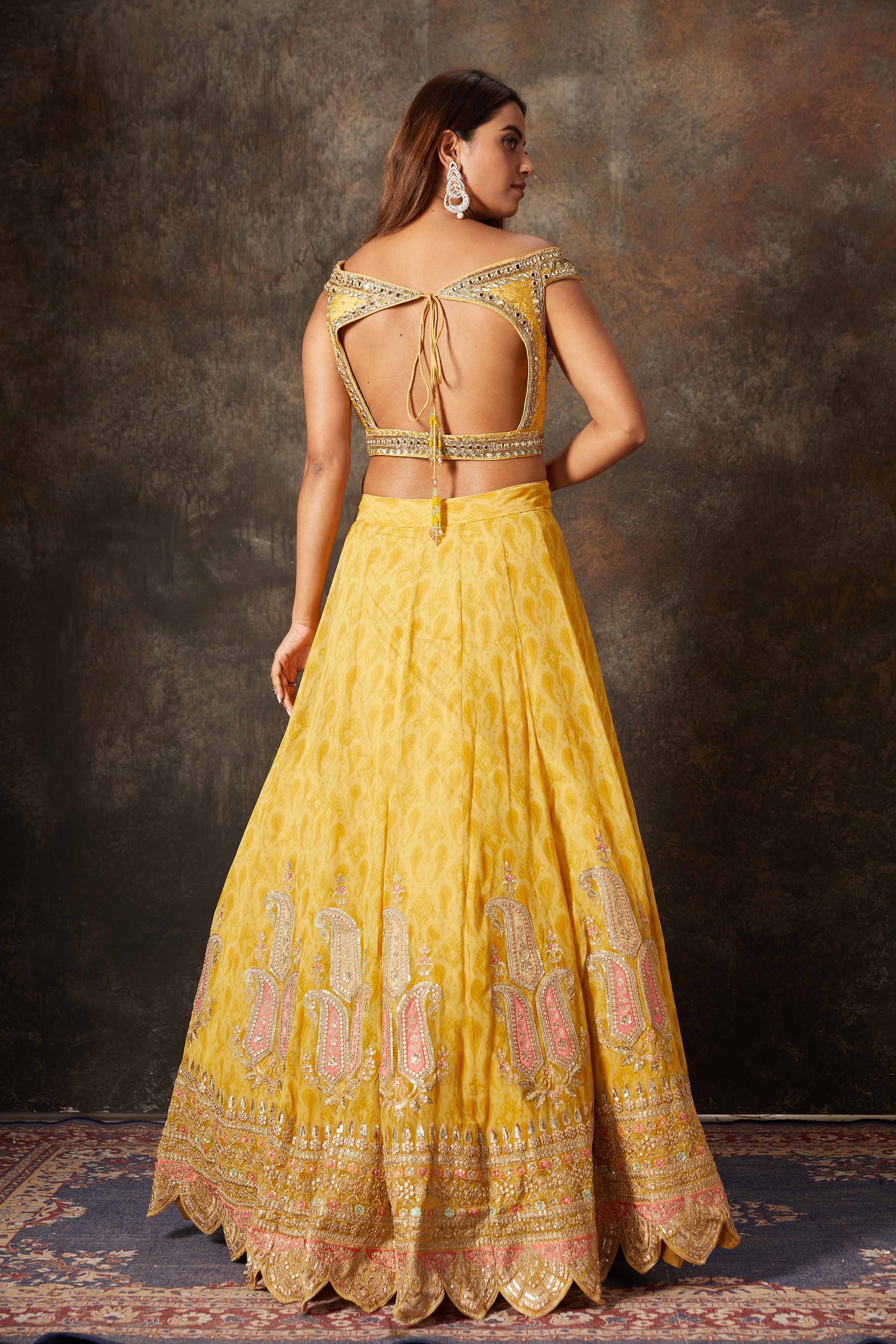 Buy mango yellow embroidered off-shoulder lehenga online in USA. Look stylish at parties and special occasions in beautiful designer sarees, embroidered sarees, handwoven silk, party sarees, lehengas, Anarkali suits from Pure Elegance Indian fashion store in USA.-back