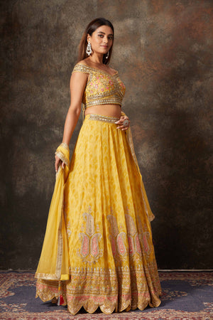Buy mango yellow embroidered off-shoulder lehenga online in USA. Look stylish at parties and special occasions in beautiful designer sarees, embroidered sarees, handwoven silk, party sarees, lehengas, Anarkali suits from Pure Elegance Indian fashion store in USA.-side