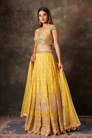 Buy mango yellow embroidered off-shoulder lehenga online in USA. Look stylish at parties and special occasions in beautiful designer sarees, embroidered sarees, handwoven silk, party sarees, lehengas, Anarkali suits from Pure Elegance Indian fashion store in USA.-left